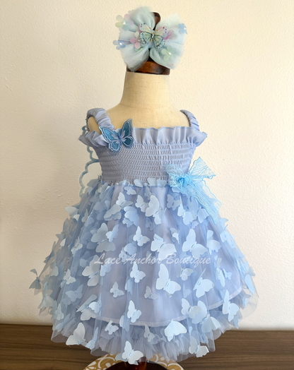 light blue girls butterfly wing fairy dress in pink on model child toddler. Has butterflies all over skirt.