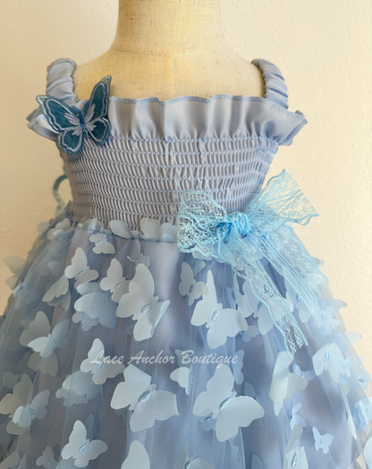 light blue girls butterfly wing fairy dress in pink on model child toddler. Has butterflies all over skirt.