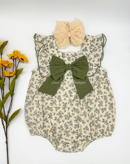 ivory baby girls romper with vintage floral print and olive green bow on chest