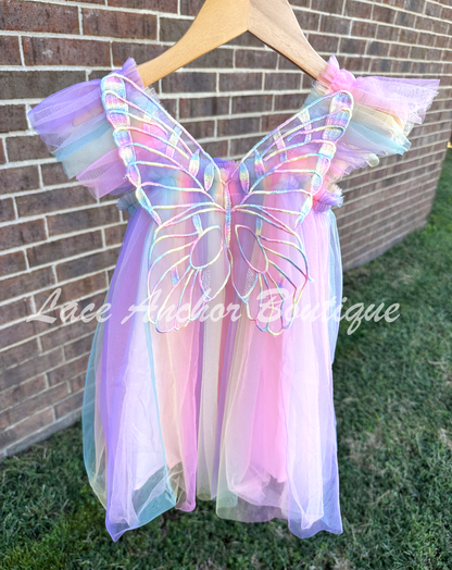 Purple rainbow fairy peach, lilac purple, light coral, pale yellow, white, teal blue knee length tulle dress with iridescent butterfly wings attached for toddlers, babies, kids.