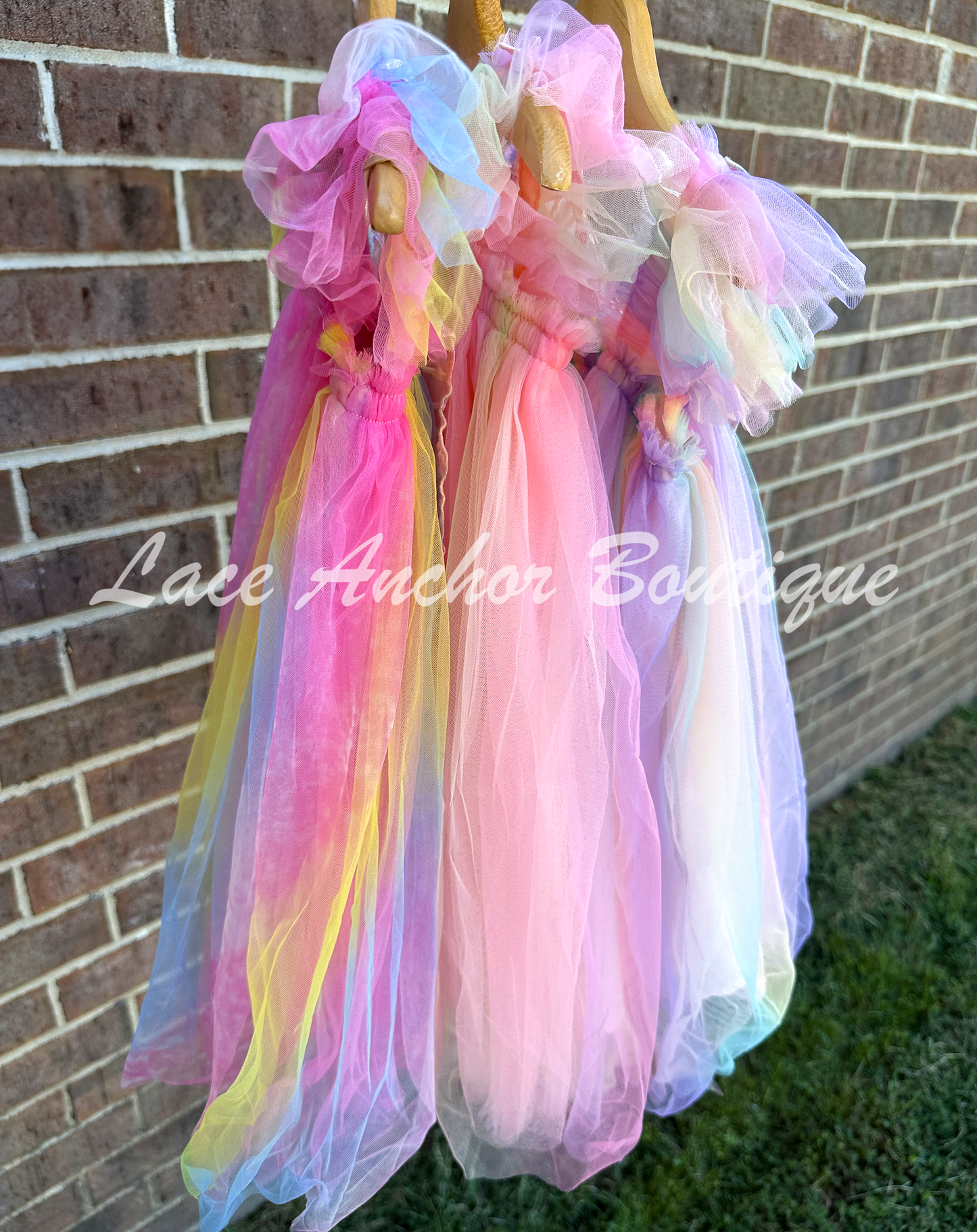 Rainbow fairy peach, lilac purple, light coral, pale yellow, white, teal blue, neon pink, neon yellow knee length tulle dresses with iridescent butterfly wings attached for toddlers, babies, kids. Dress for girls.