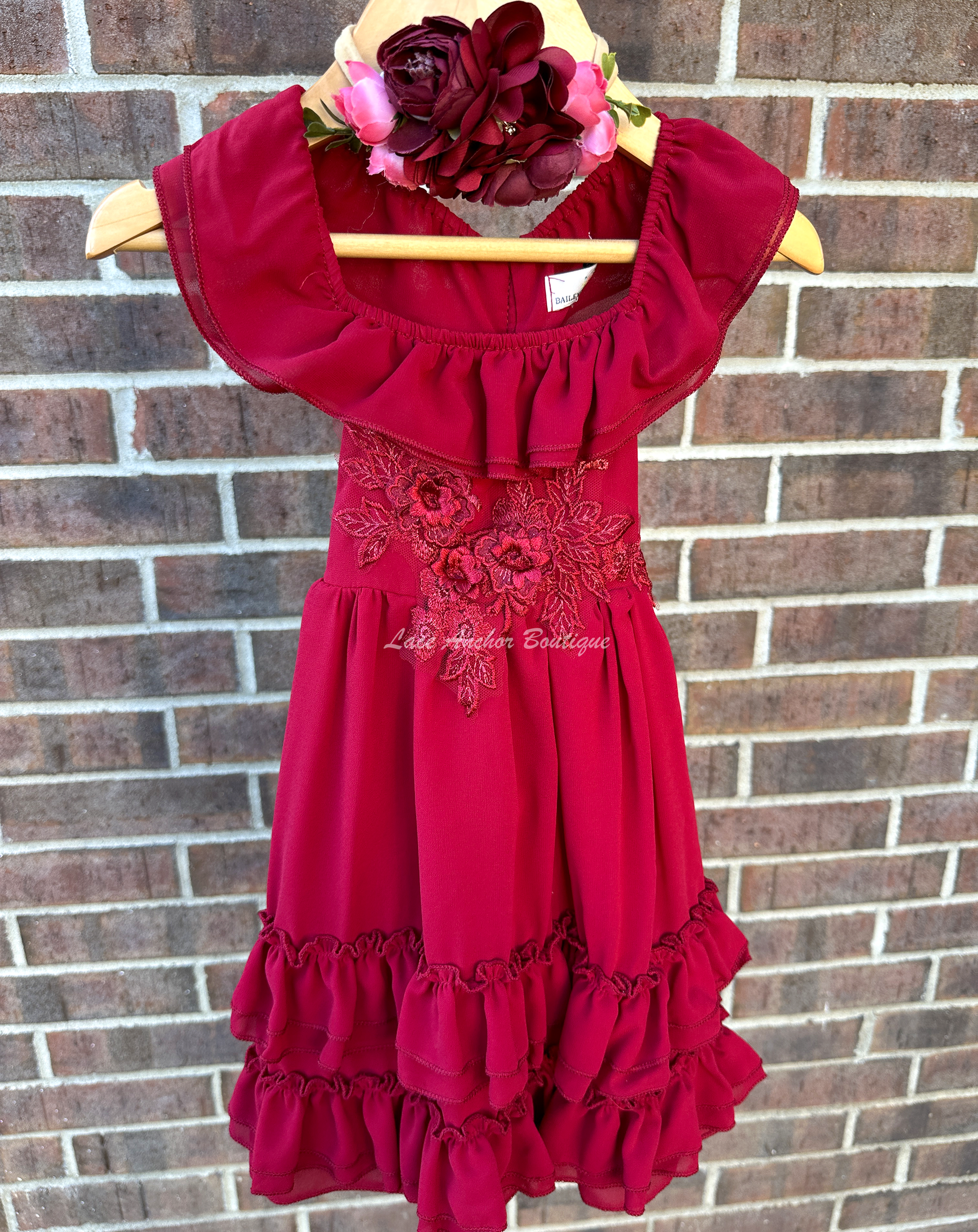 solid deep red ruffled layer dress with floral embroidered applique. Holiday sleeveless maxi dress.