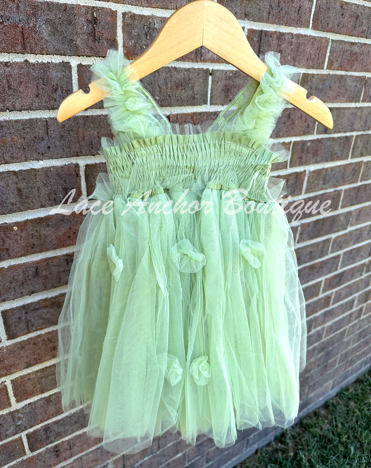 Sage Green tulle fairy girls dress with smocked top and tulle flowers on skirt. Attached butterfly wings and ruffled straps.