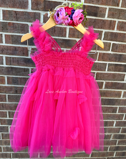 hot pink tulle fairy girls dress with smocked top and tulle flowers on skirt. Attached butterfly wings and ruffled straps.