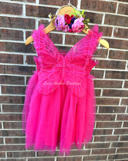 hot pink tulle fairy girls dress with smocked top and tulle flowers on skirt. Attached butterfly wings and ruffled straps.