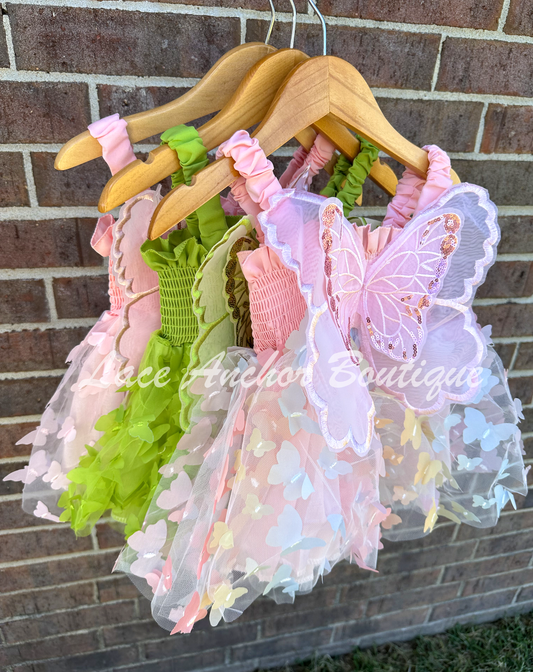 Girls butterfly wing dresses in pink, rainbow, and green. Attached fairy wings toddler baby dress.