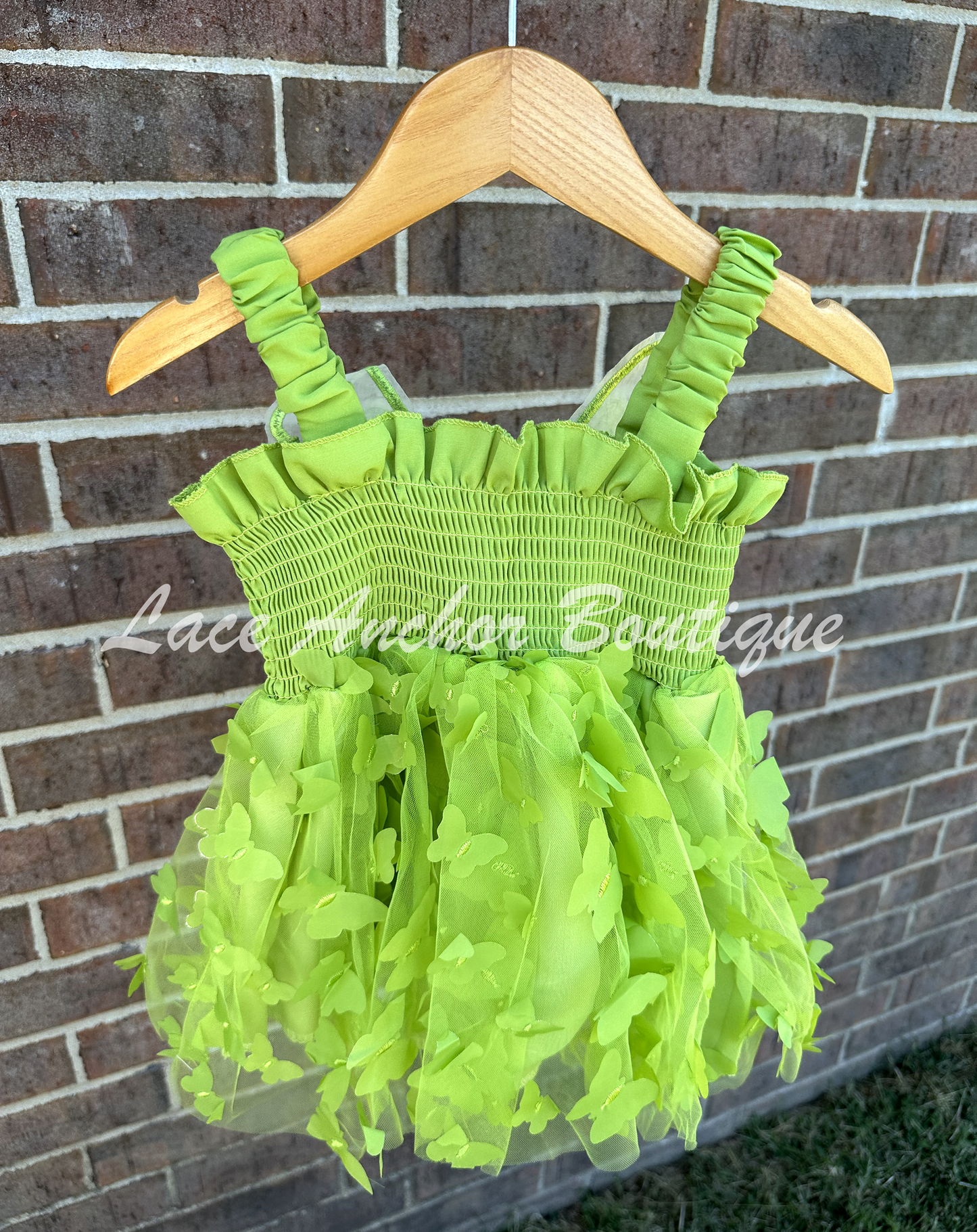 Lime green color girls butterfly wing fairy dress in sage child toddler dress. Has green colored butterflies all over skirt and attached wings.