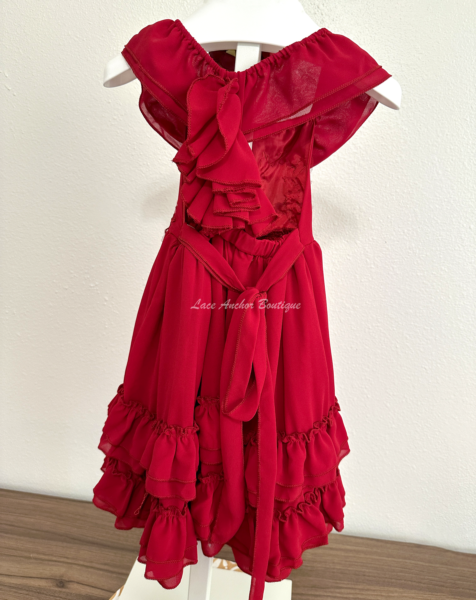 solid deep red ruffled layer dress with floral embroidered applique. Holiday sleeveless maxi dress.