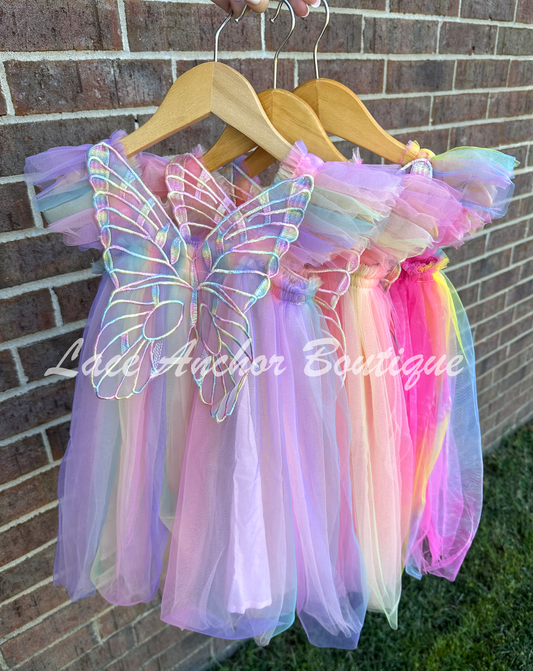 Rainbow fairy peach, lilac purple, light coral, pale yellow, white, teal blue, neon pink, neon yellow knee length tulle dresses with iridescent butterfly wings attached for toddlers, babies, kids. Dress for girls.