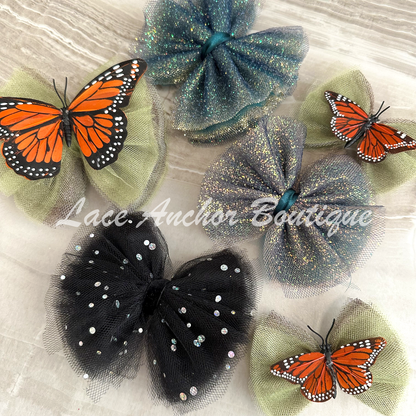 sage green tulle girls hair bow with orange monarch butterfly center. Girl clip hair bow.