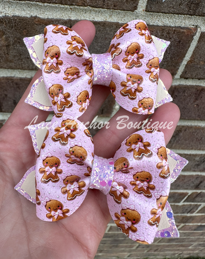 pink gingerbread girl with bows hair bow clip. Pink glitter girls hair clips with pink glitter on faux leather.