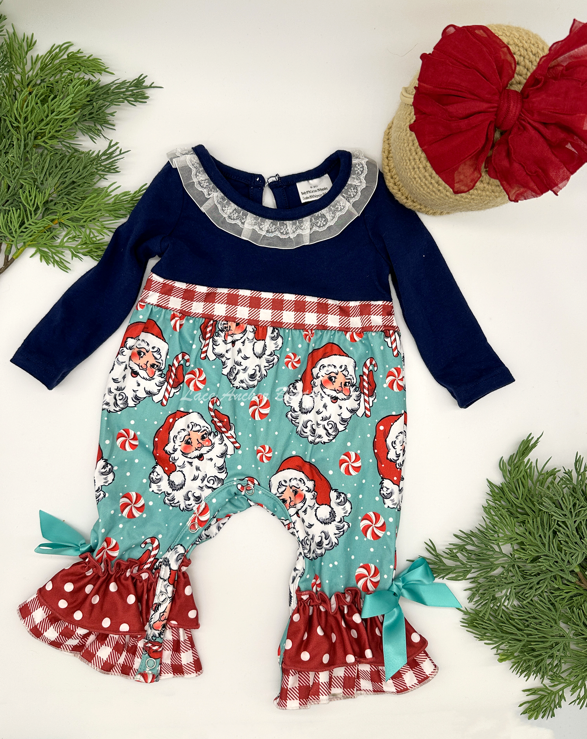 Santa Claus themed baby girls romper with candy canes, red gingham print, and lace collar.