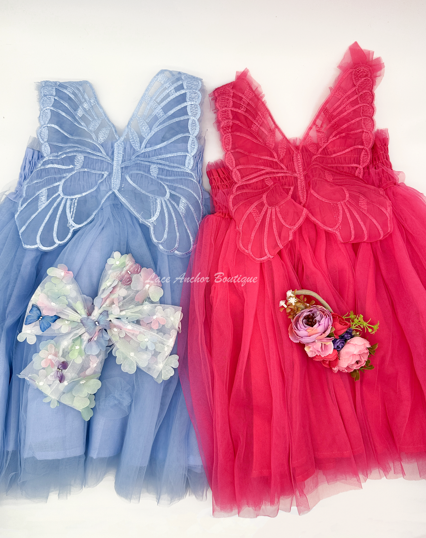 hot pink tulle or light blue fairy girls dresses with smocked top and tulle flowers on skirt. Attached butterfly wings and ruffled straps.