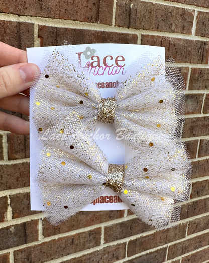 Gold spec girls hair bow with sequin glitter sparkles. White toddler girl piggie bow.