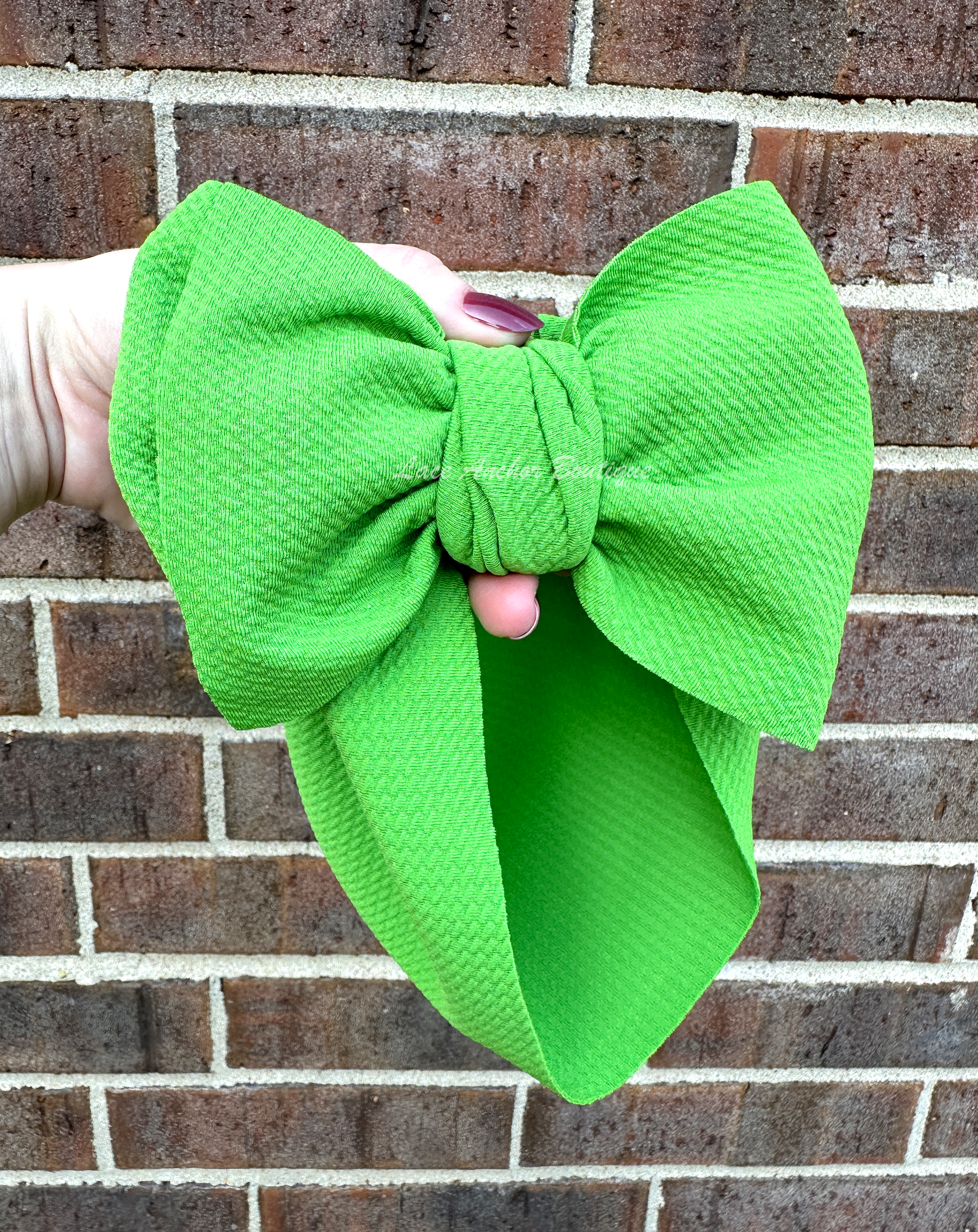 bold colored solid green bullet fabric headwraps for babies. Baby girl big bow hair bows.