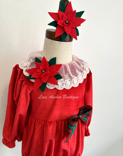 Christmas themed baby girls romper with red velvet, lace collar, 3D felt poinsettia flowers, and a vintage green and red bow.