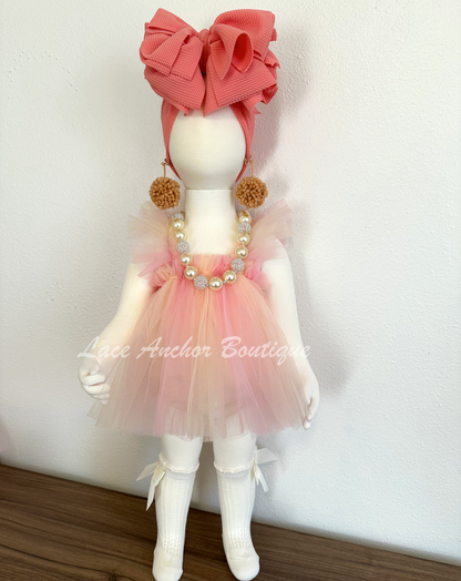 baby girls pastel peach, coral skirted romper with fairy wings. Girls dress with embroidered butterfly wings.