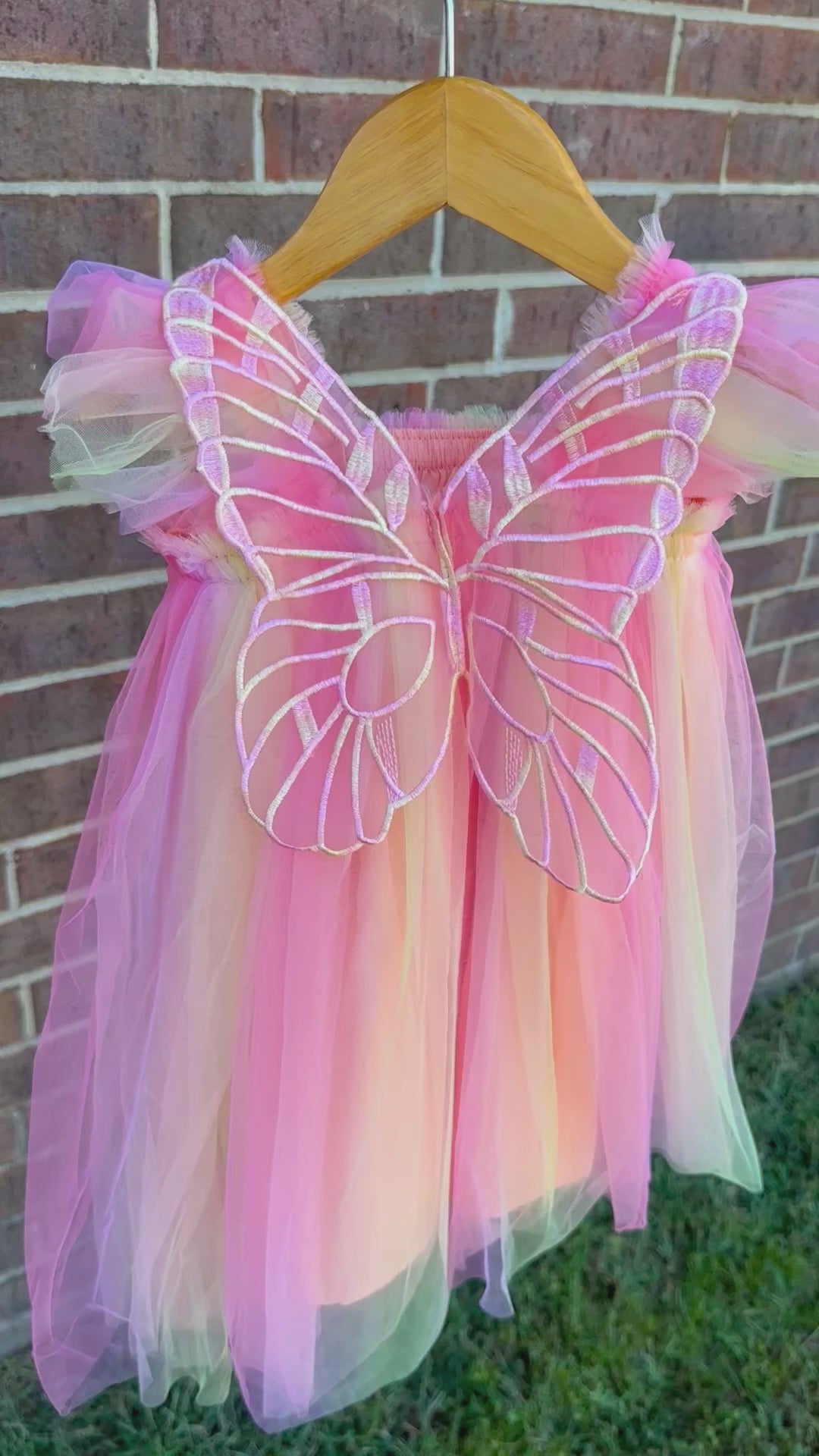 Peachy rainbow fairy peach, lilac purple, coral, pale yellow knee length tulle dress with iridescent butterfly wings attached for toddlers, babies, kids.