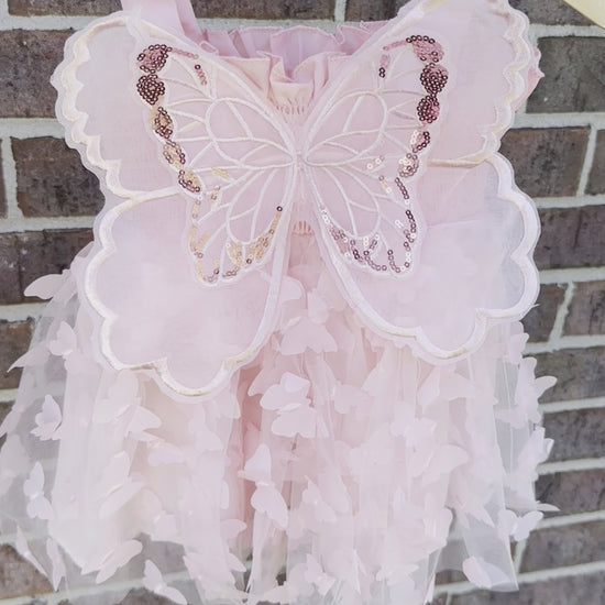 Light blush pale pink girls butterfly wing fairy dress in pink child toddler dress. Has butterflies all over skirt.