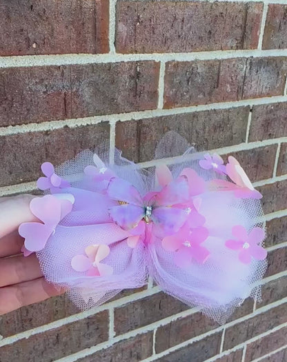 light pink tulle hair bow with flowers and pink and gold butterfly center for toddler girls and up..